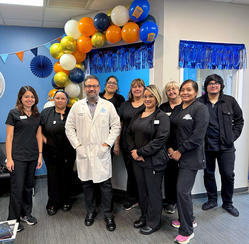 Chandler, AZ physician and staff at Grand Opening in office with balloons