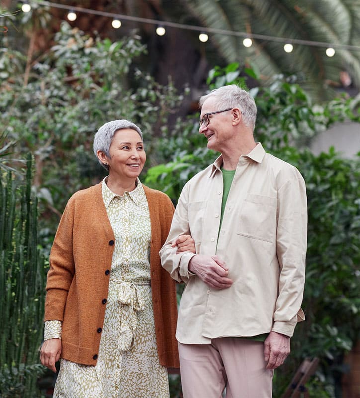 senior couple walking in gardens