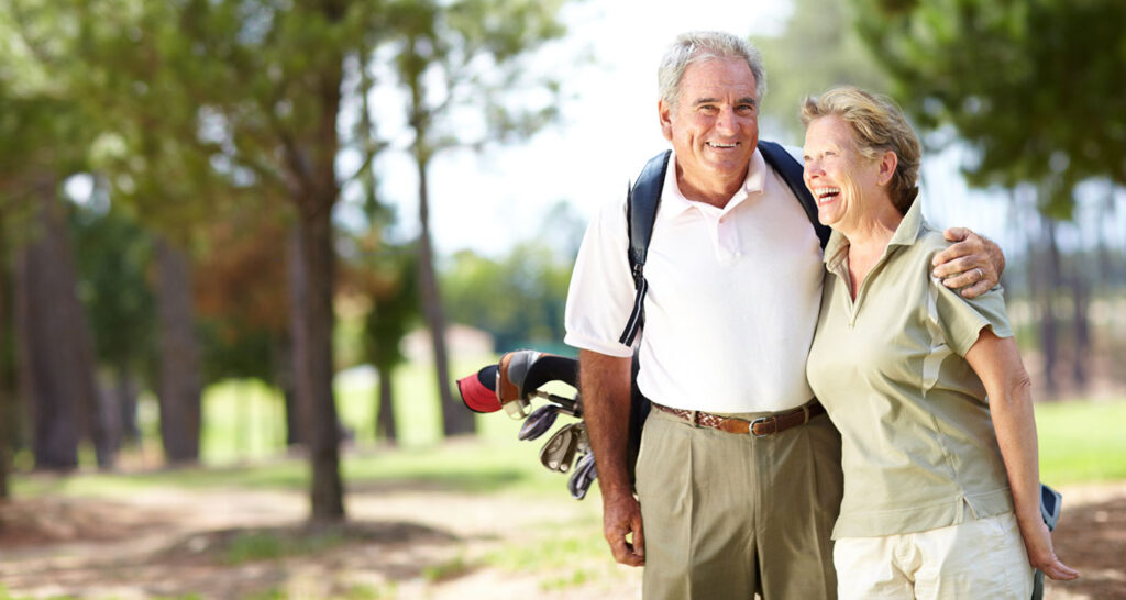 senior couple golfing